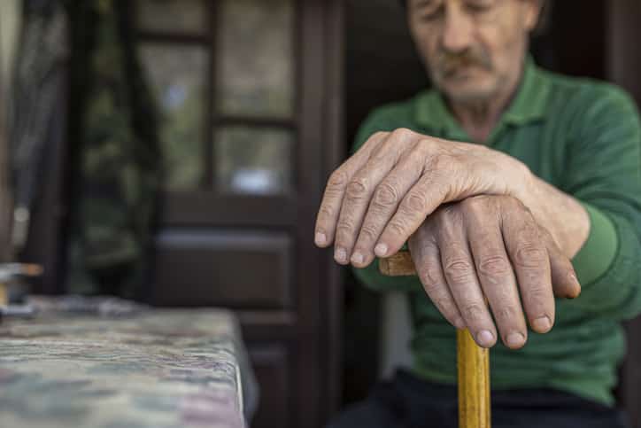 man with cane at home