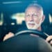 Senior man having bad eye sight and making effort to see the road.