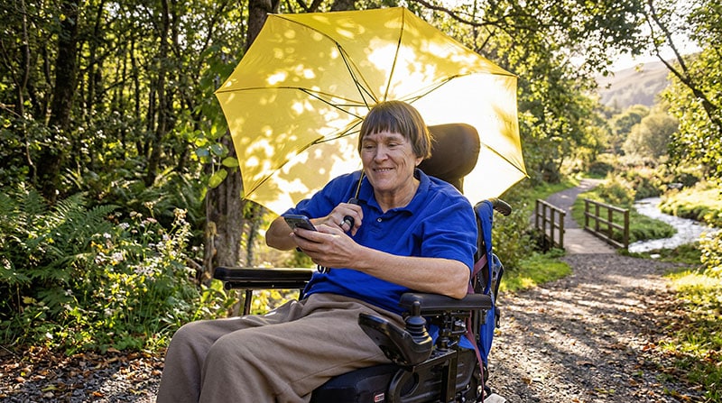 person with ms in wheelchair and umbrella